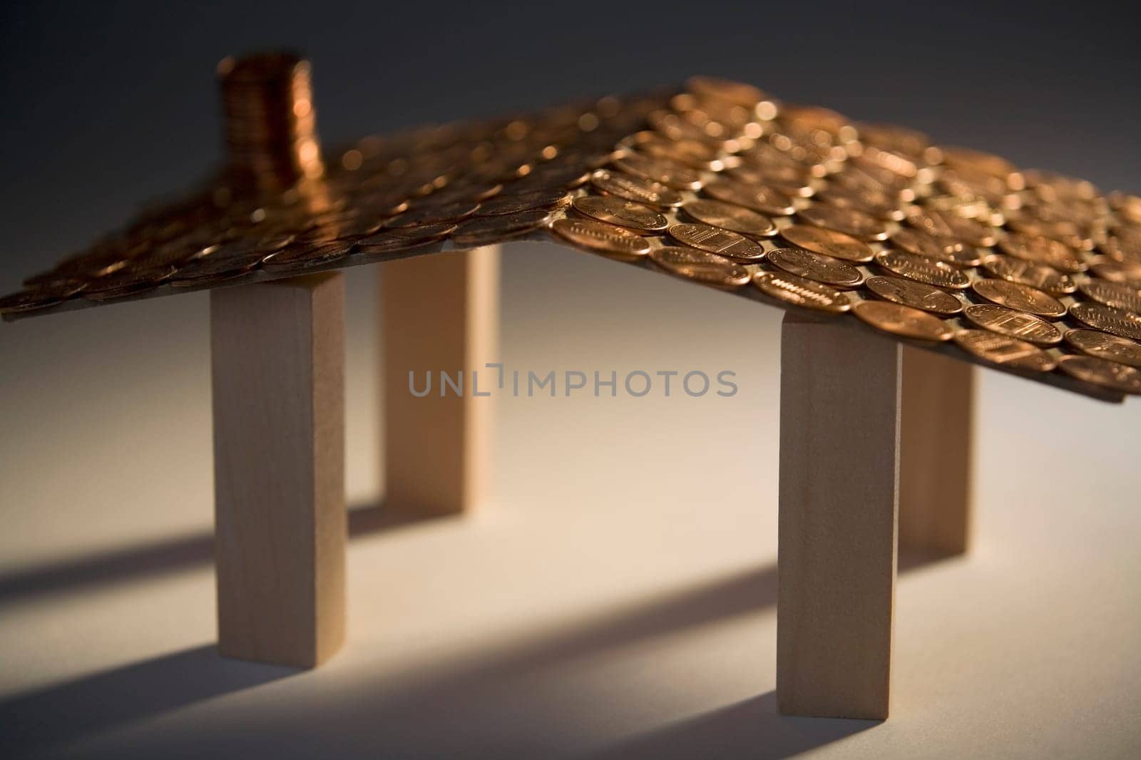Close-up of a model of a house made with coins