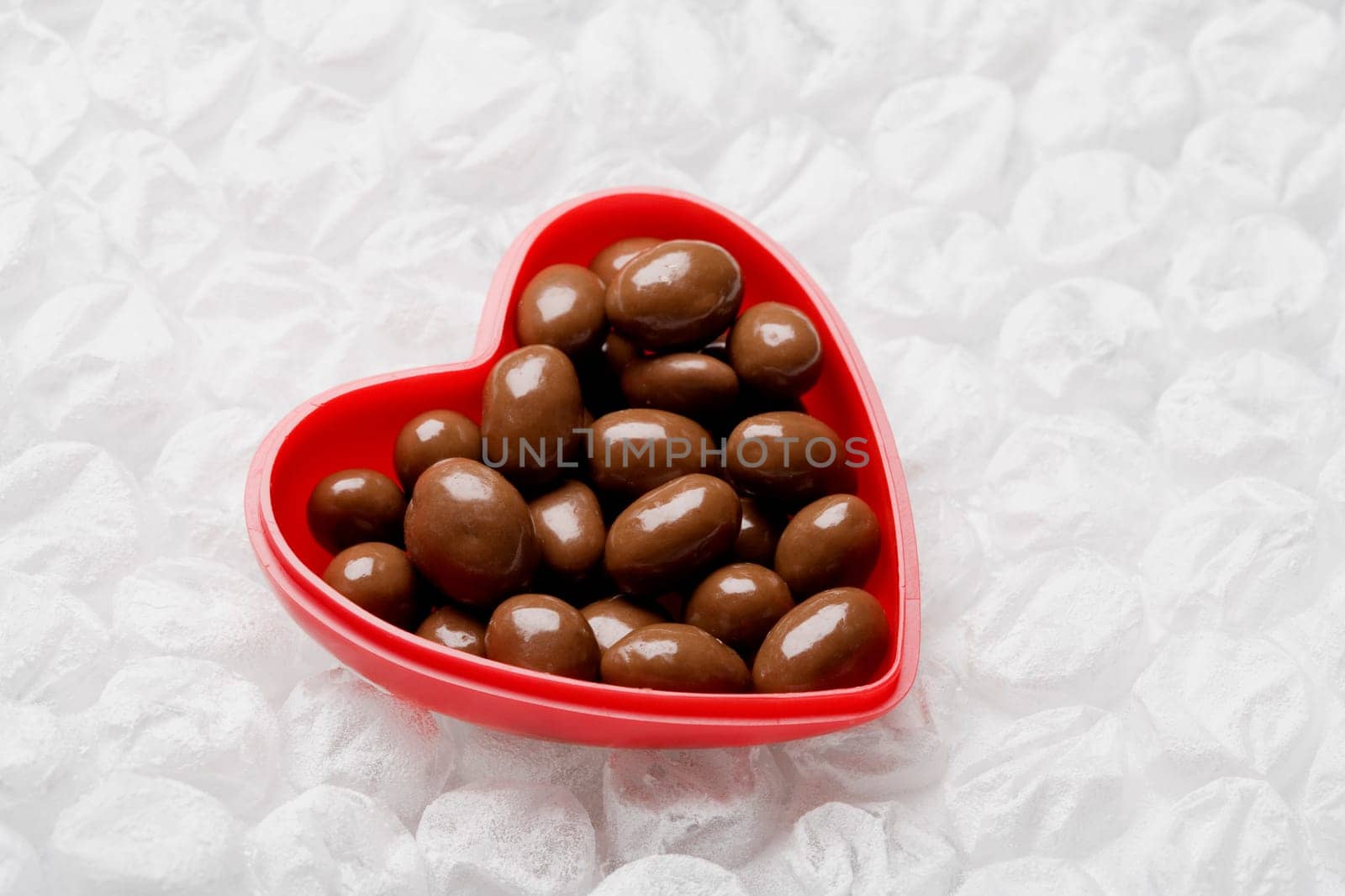 Close-up of chocolates in a heart shaped container