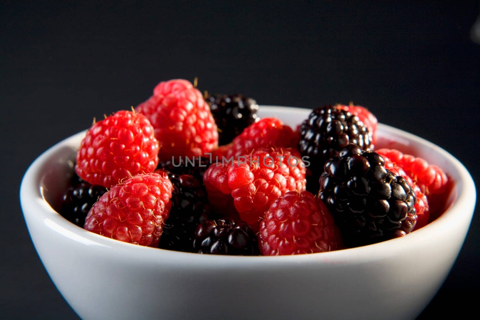 Close-up of raspberries and blackberries in a bowl