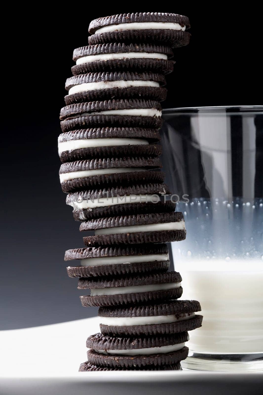 Close-up of a glass of milk with stack of cookies