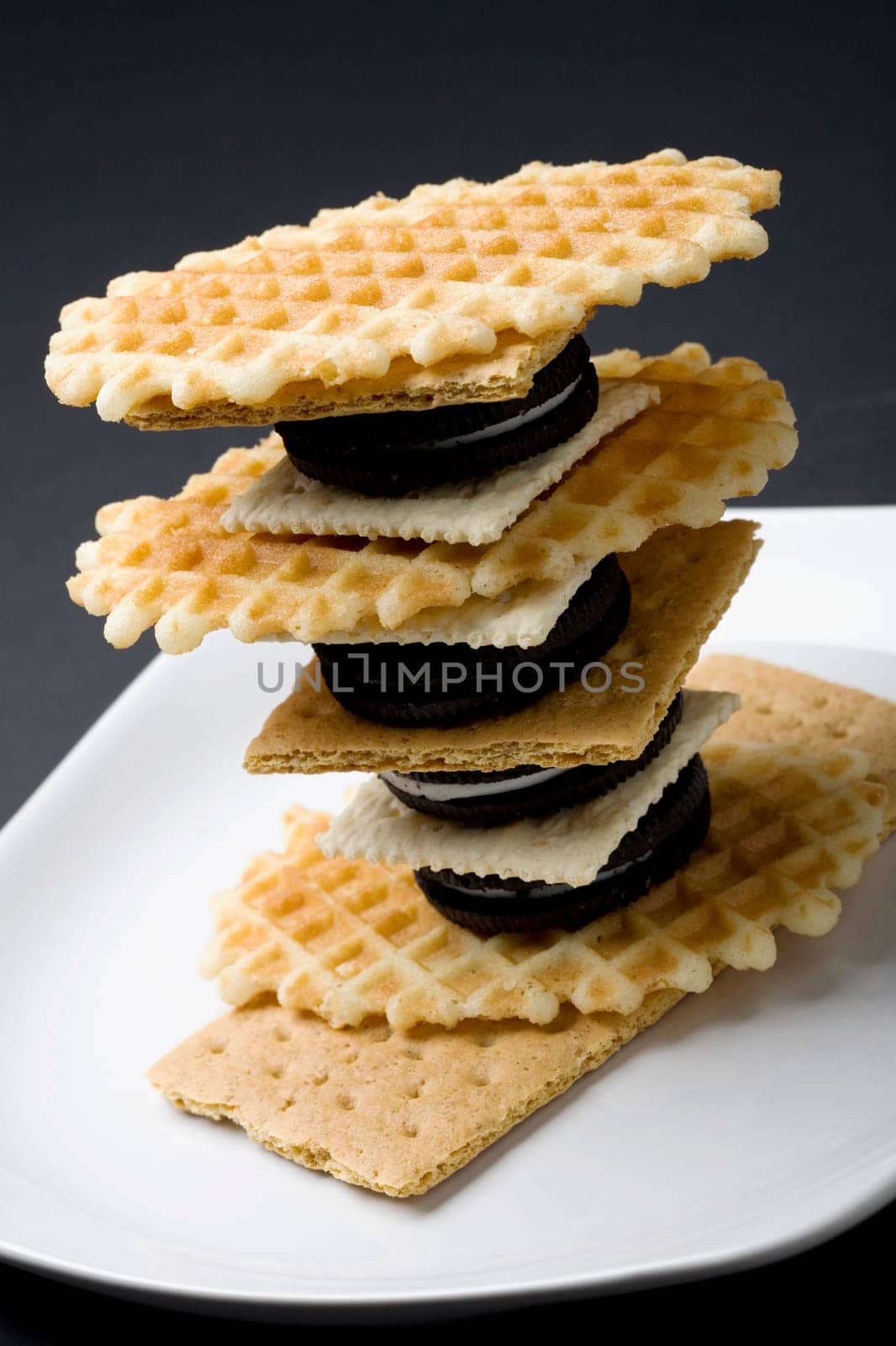 Close-up of a stack of waffles with crackers and cookies