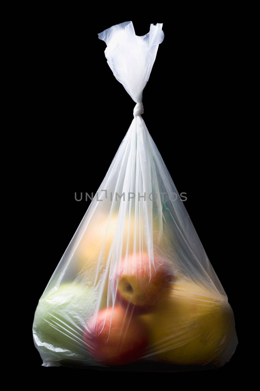 Close-up of two apples and three oranges in a plastic bag