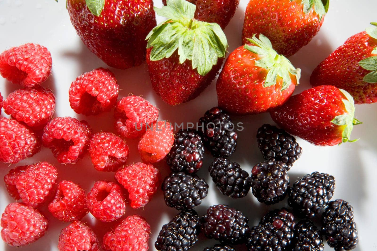 Close-up of strawberries with blackberries and raspberries