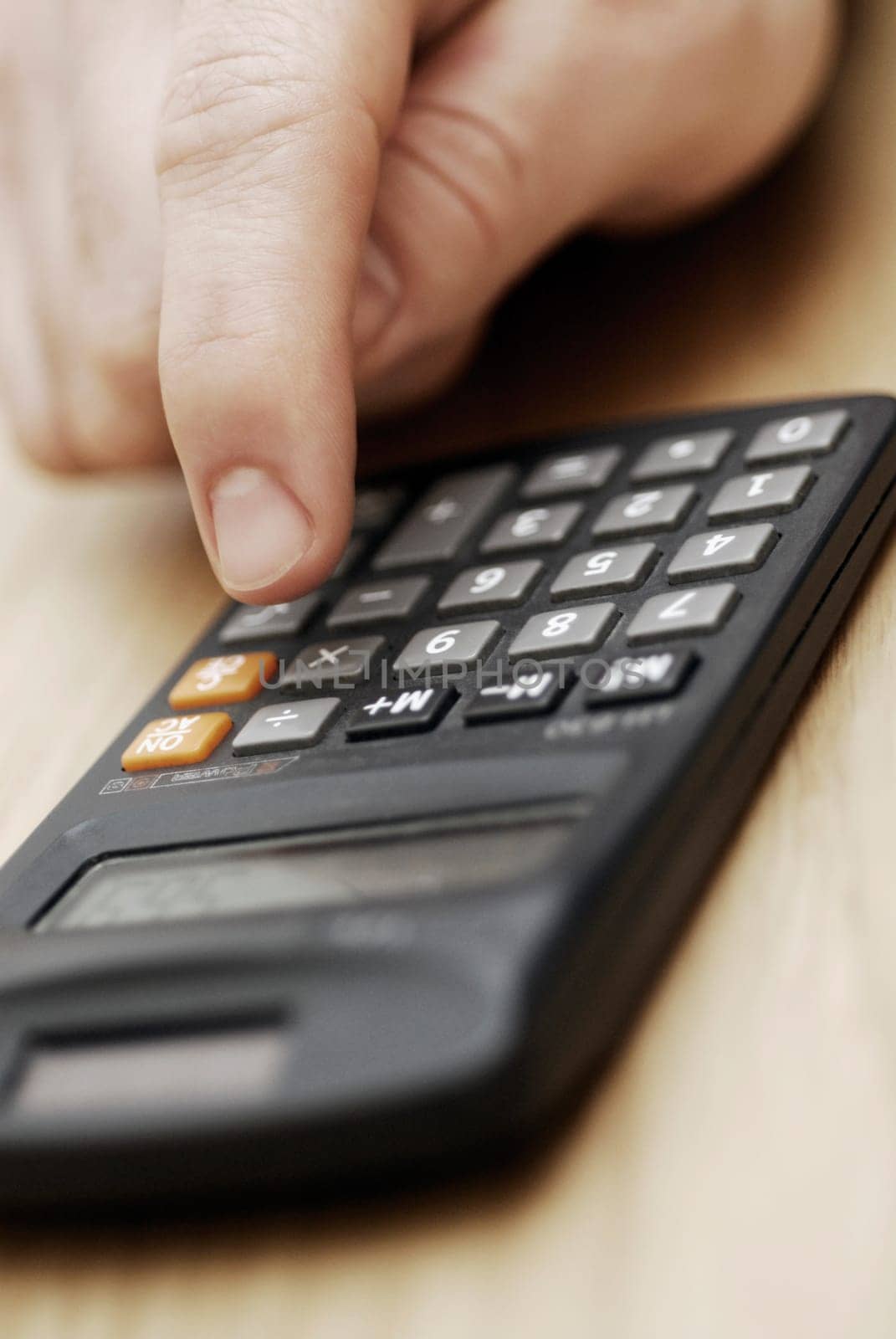 Close-up of a personŽs hand using a calculator