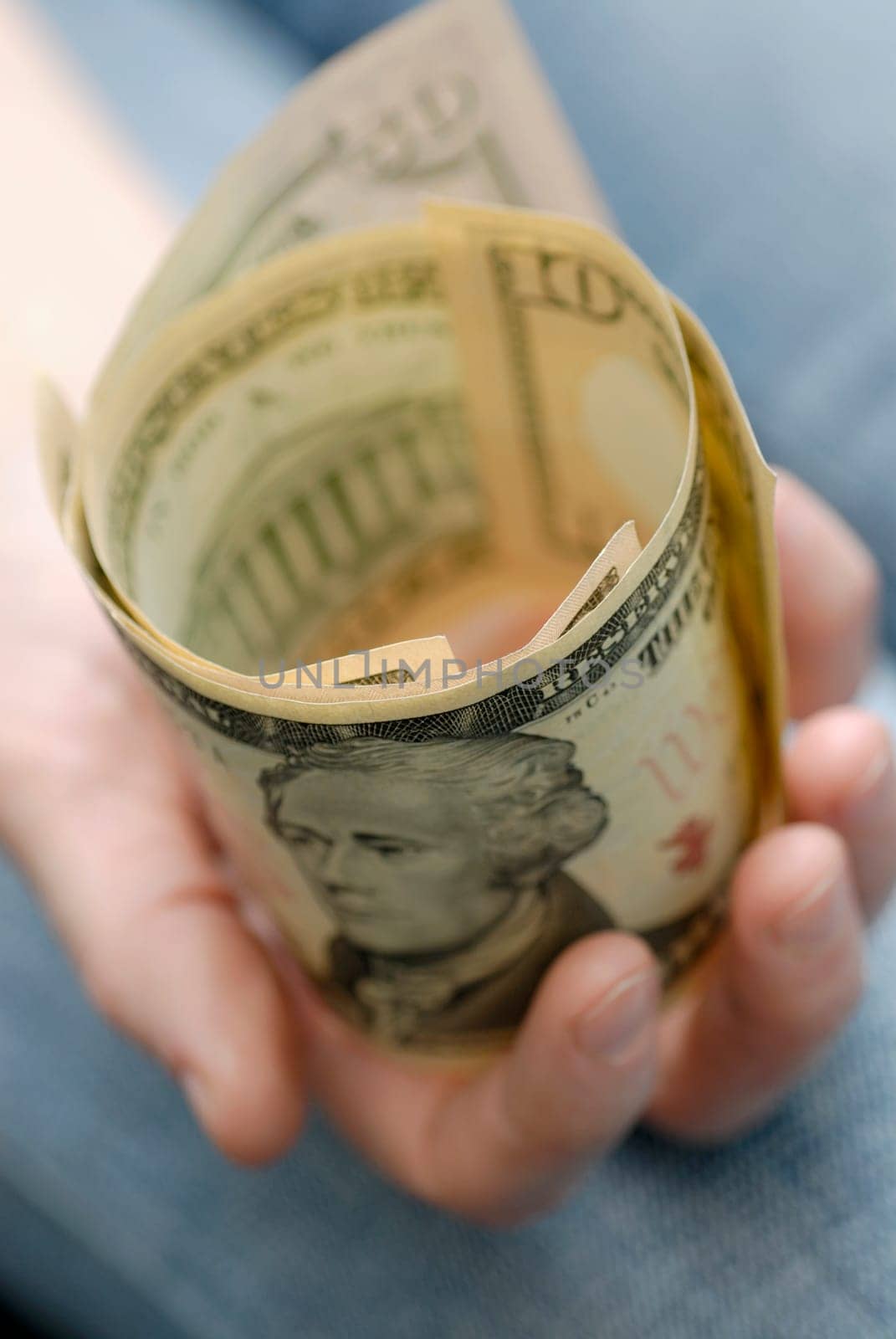 Close-up of a personŽs hand holding American dollar bills