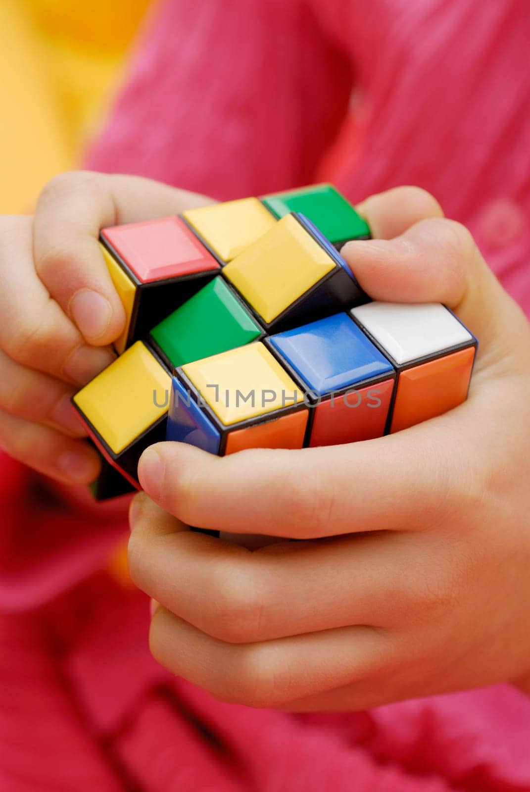 Mid section view of a person playing with a puzzle cube