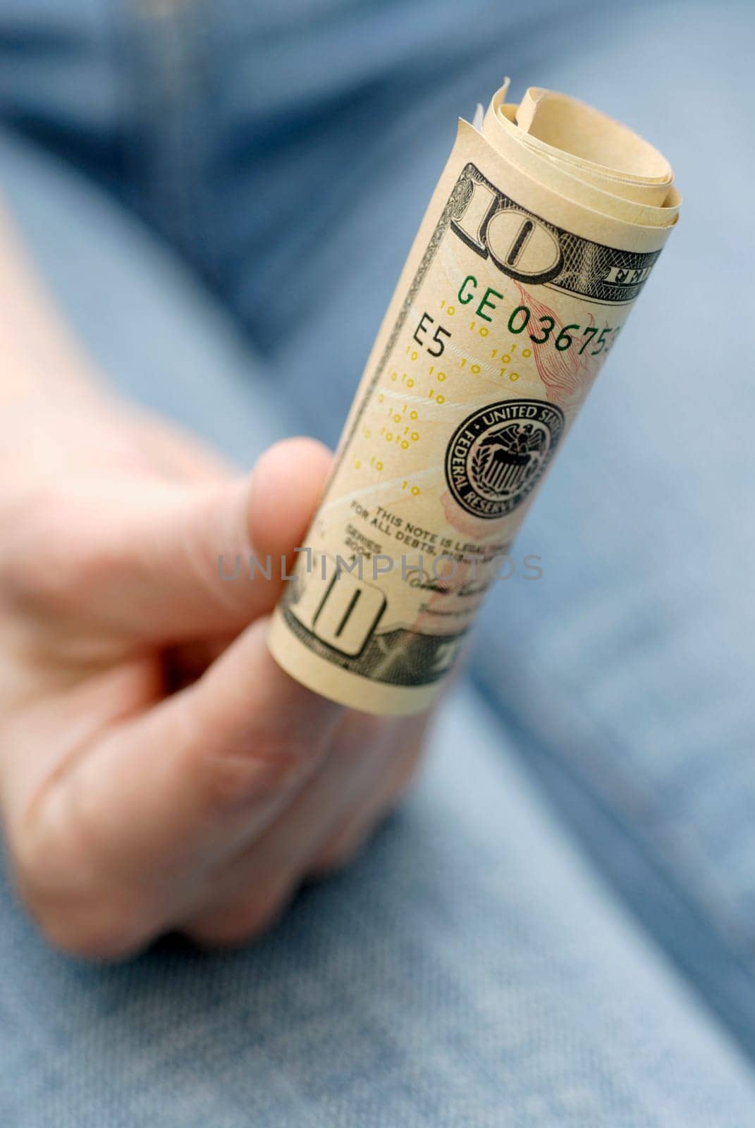 Close-up of a personŽs hand holding American bank notes