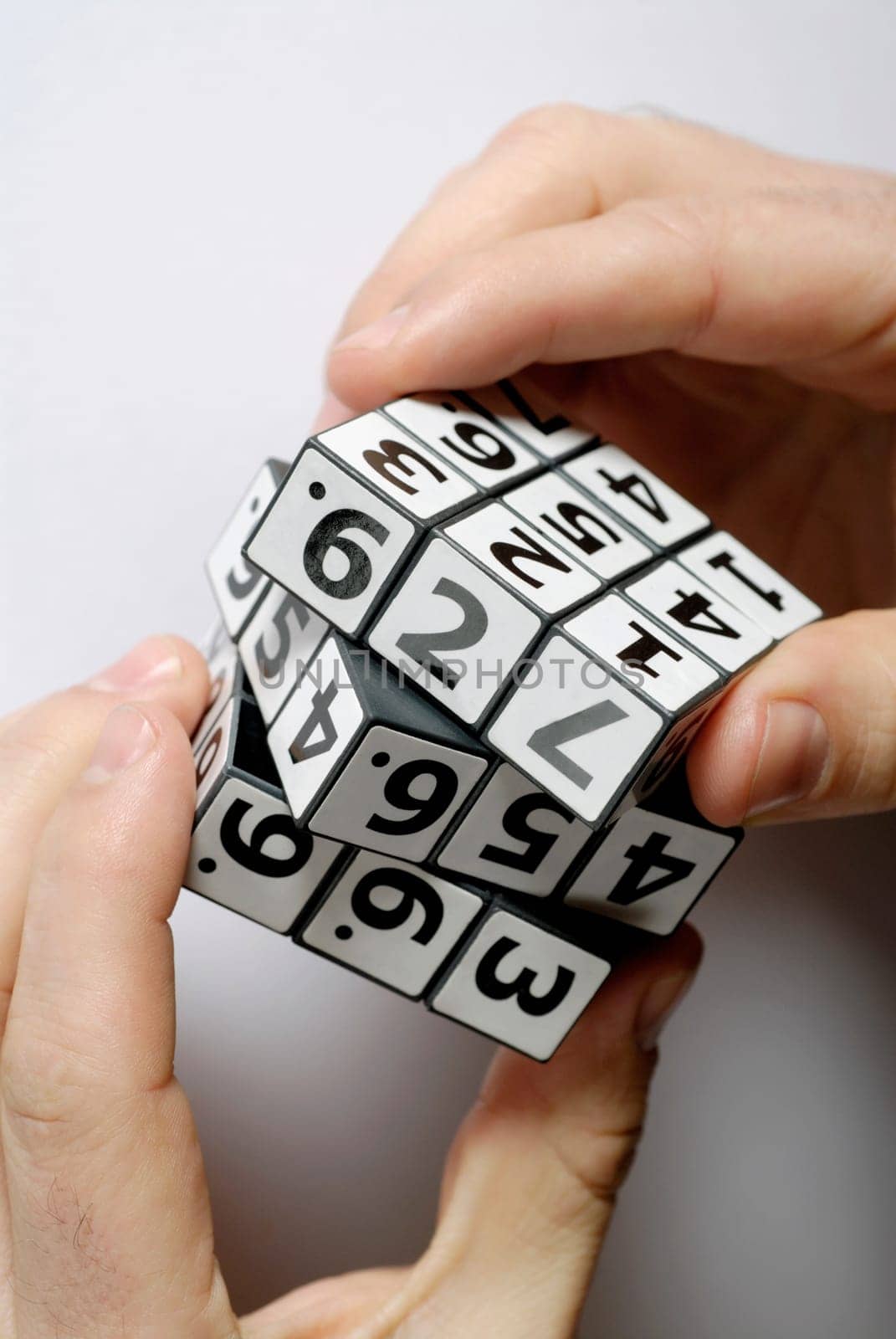 Close-up of a personŽs hands playing with a puzzle cube