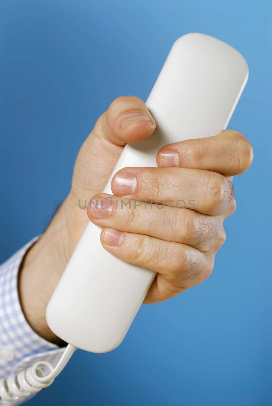 Close-up of a personŽs hand holding a telephone receiver