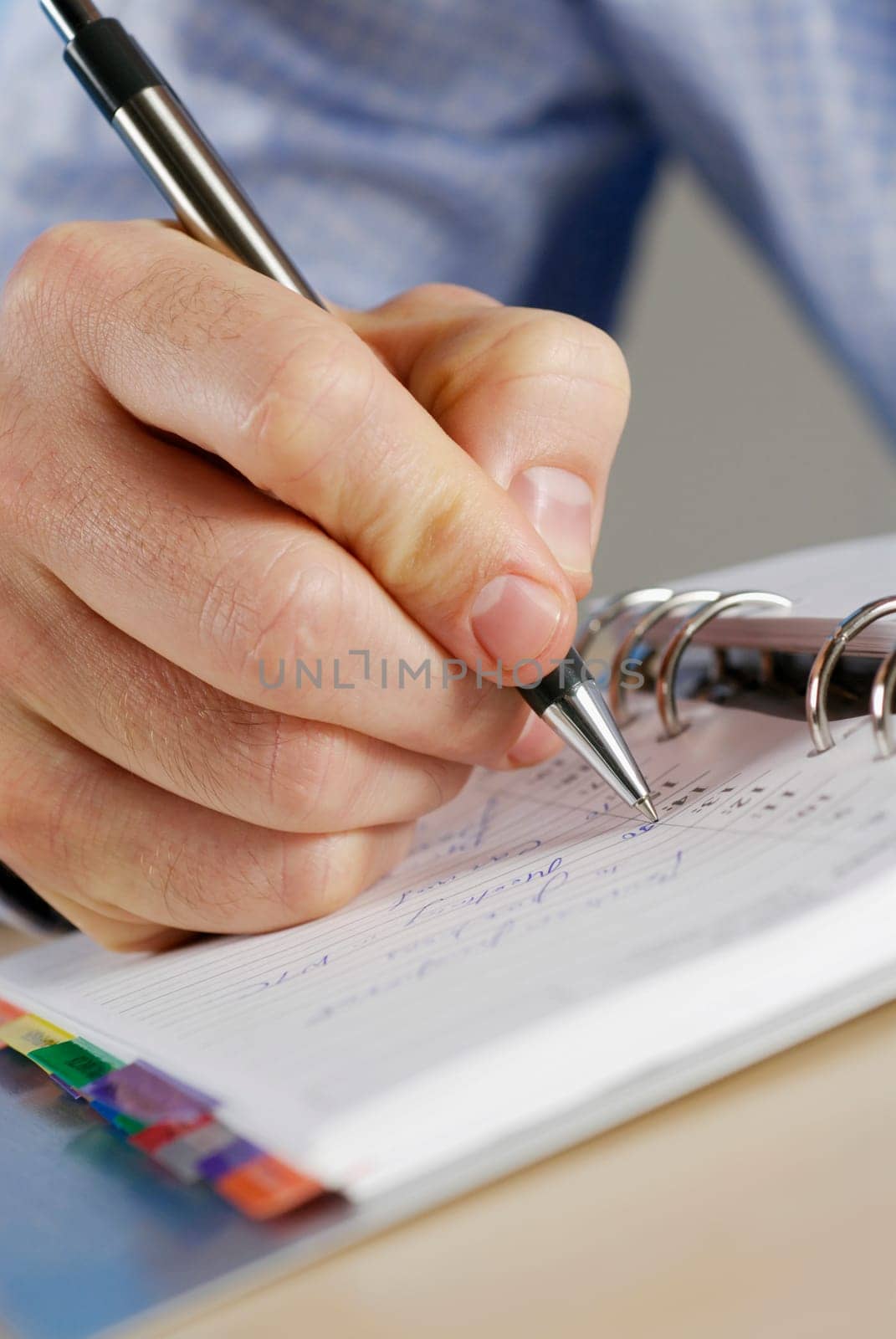 Close-up of a personŽs hand writing in a diary
