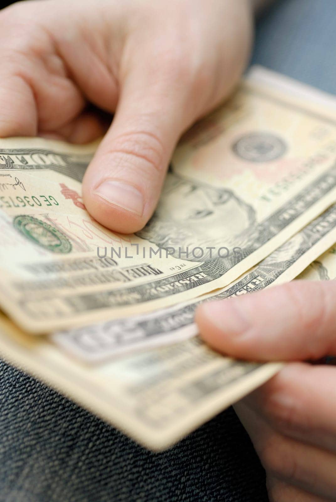 Close-up of a personŽs hands holding American dollar bills