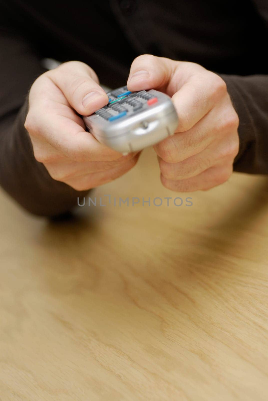 Close-up of a manŽs hand operating a remote control