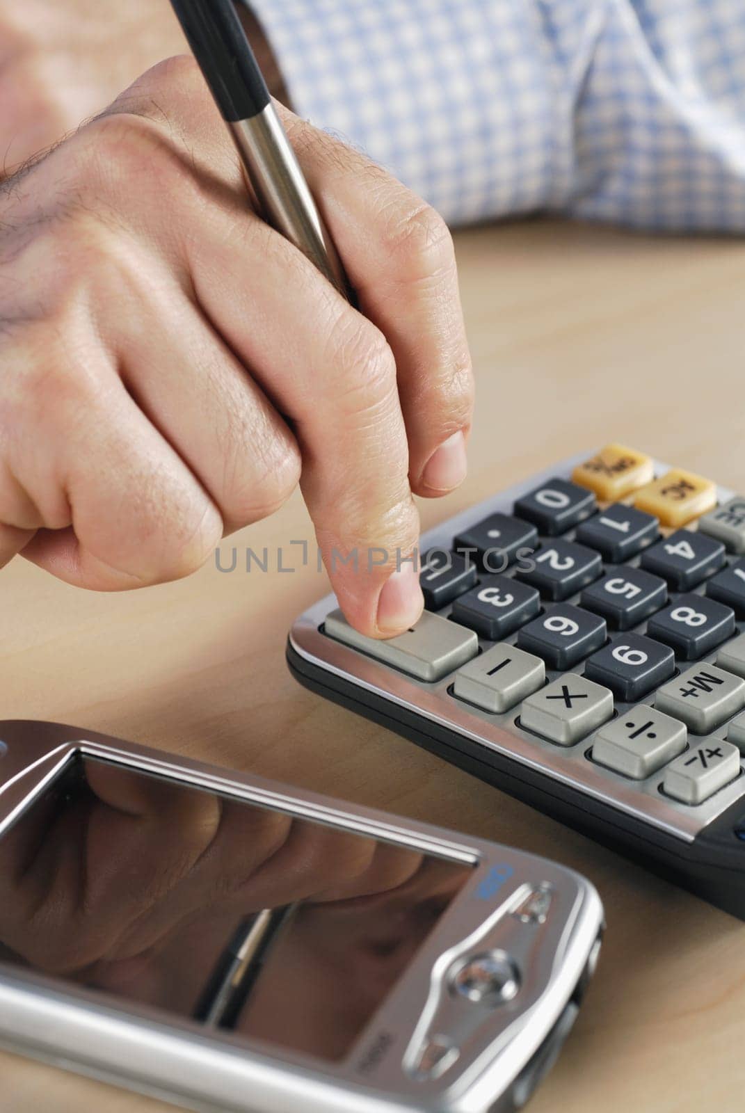 Close-up of a personŽs hand using a calculator