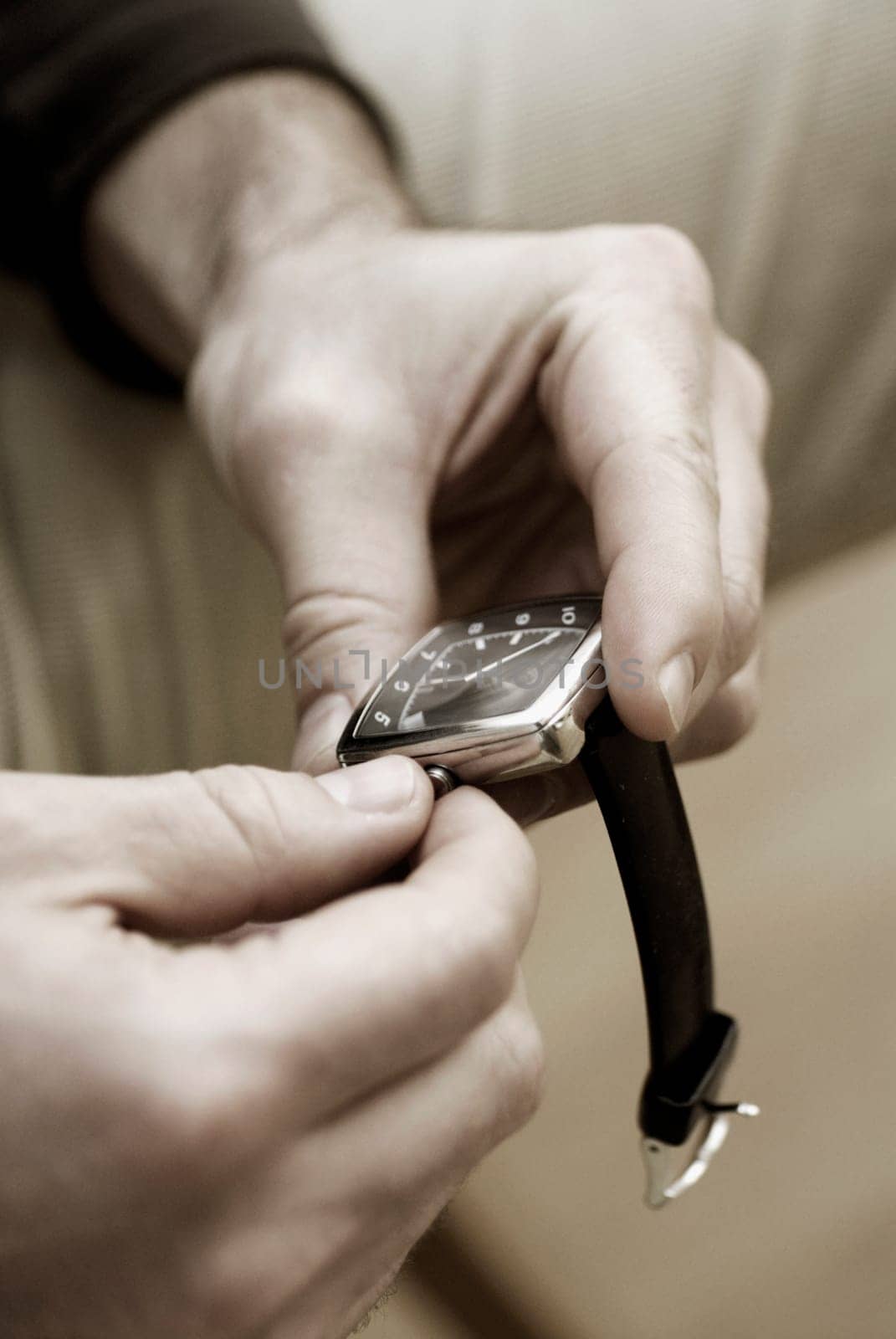 Close-up of a personŽs hand adjusting the time on a wristwatch