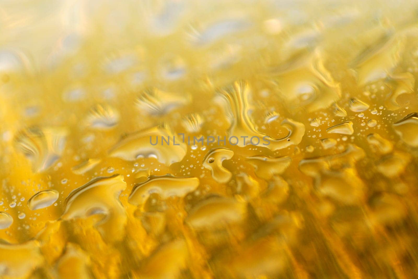 Close-up of water drops on a yellow surface