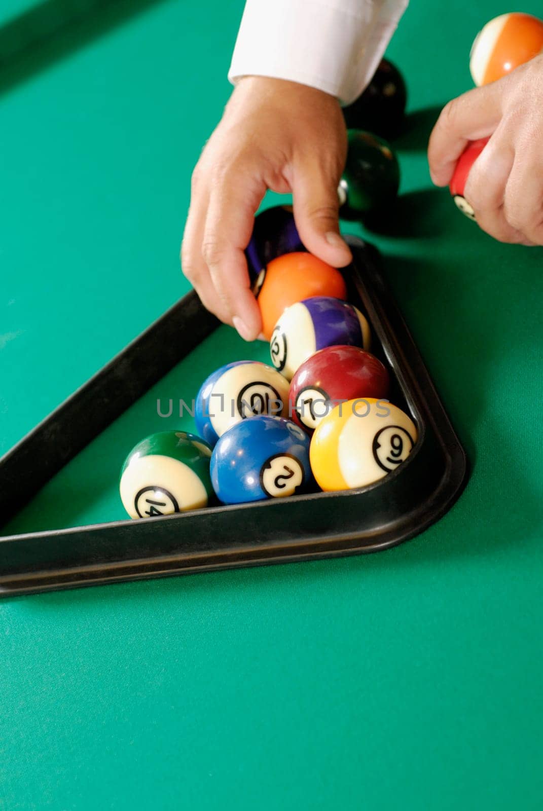 Close-up of a personŽs hand arranging pool balls