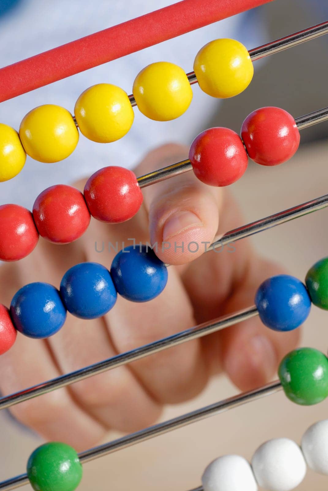 Close-up of a personŽs hand using an abacus