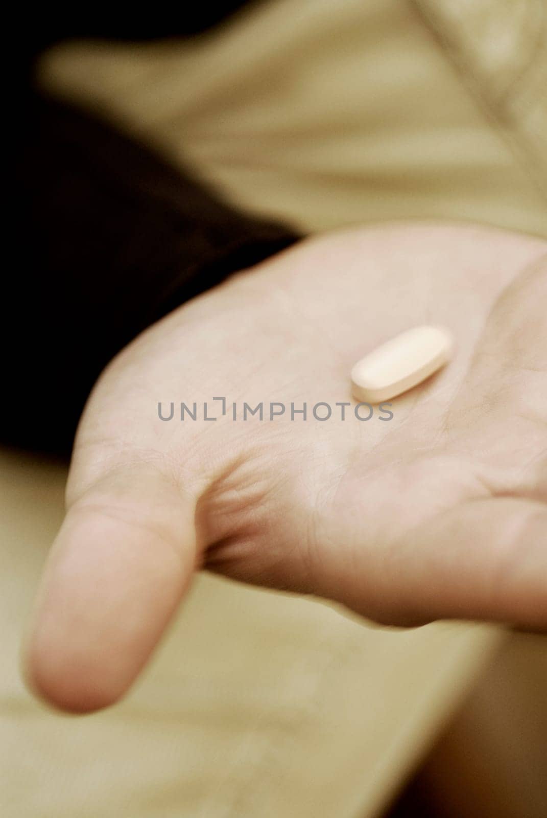 Close-up of a pill on a personŽs hand