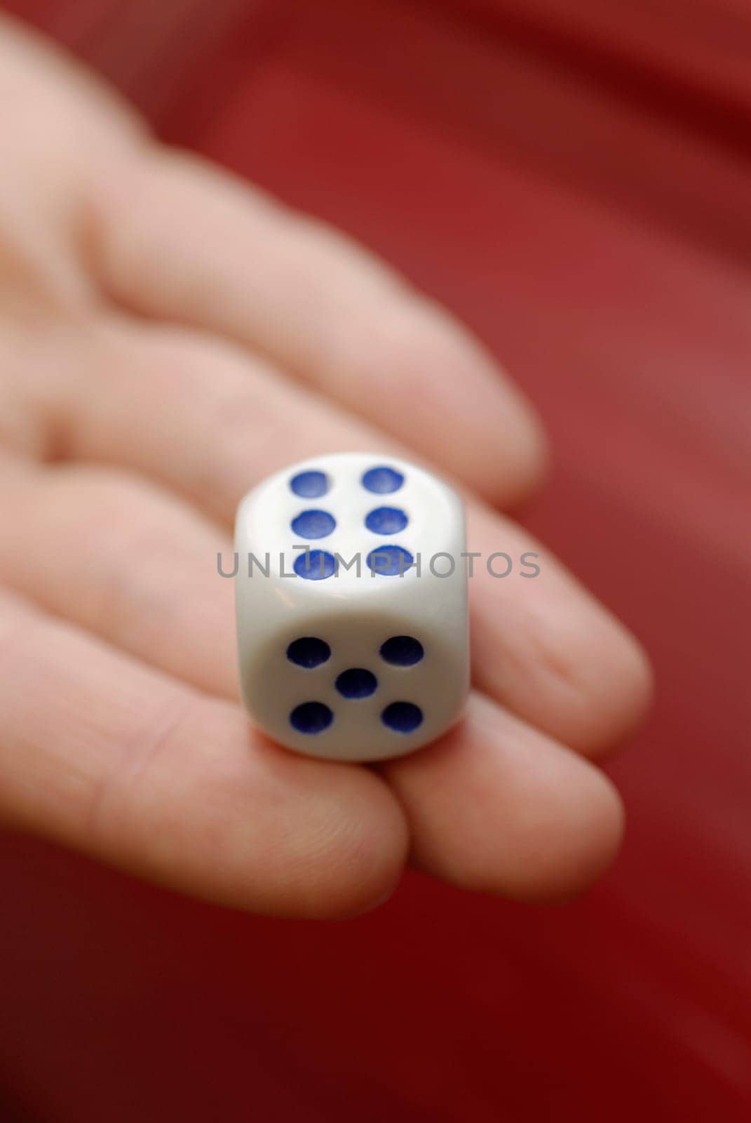 Close-up of a personŽs hand holding a dice