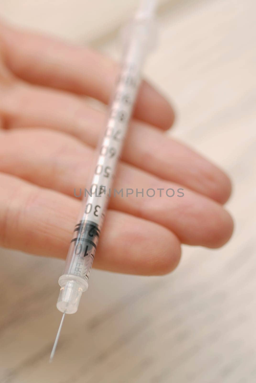 Close-up of a syringe on a personŽs hand