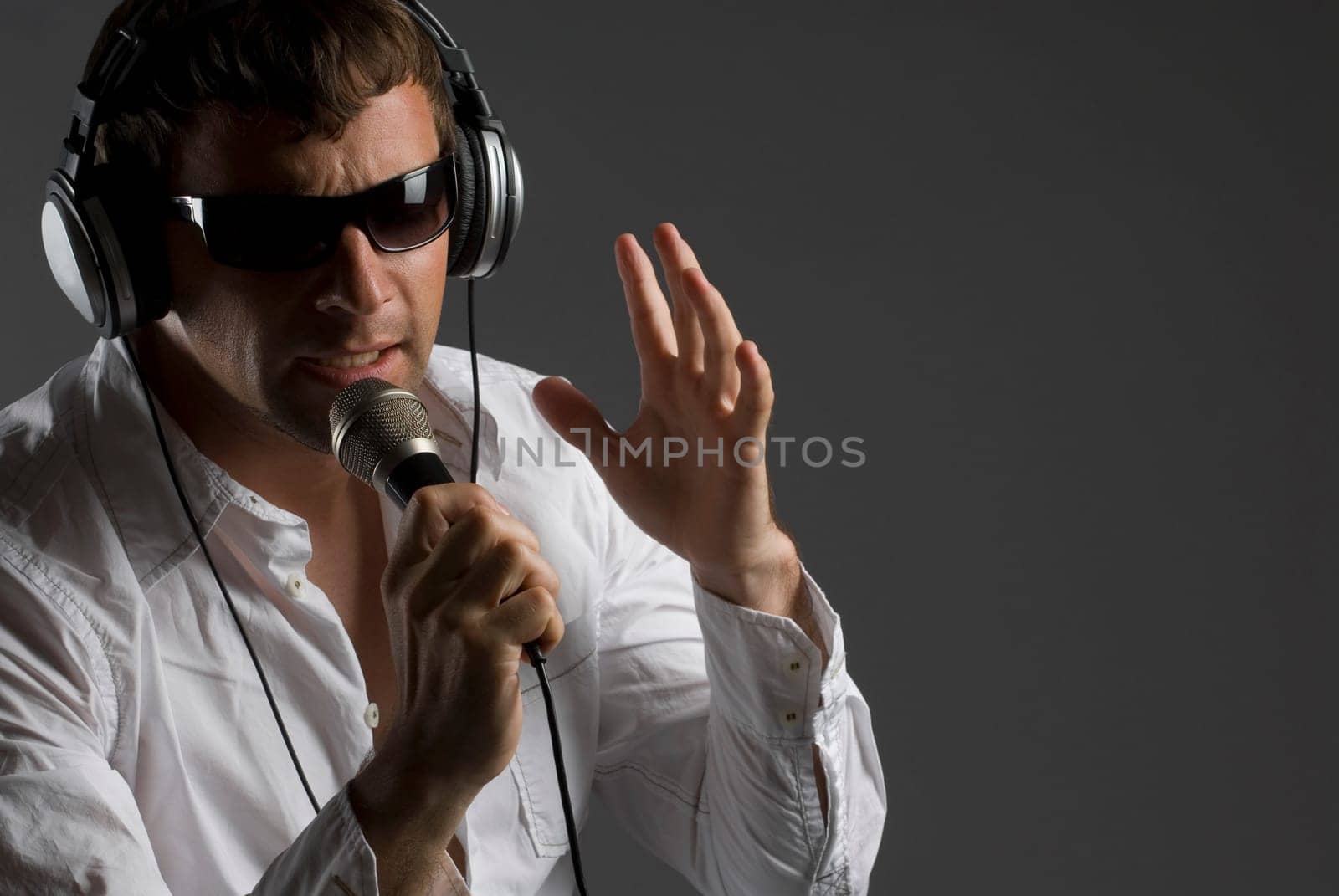 Close-up of a young man singing into a microphone