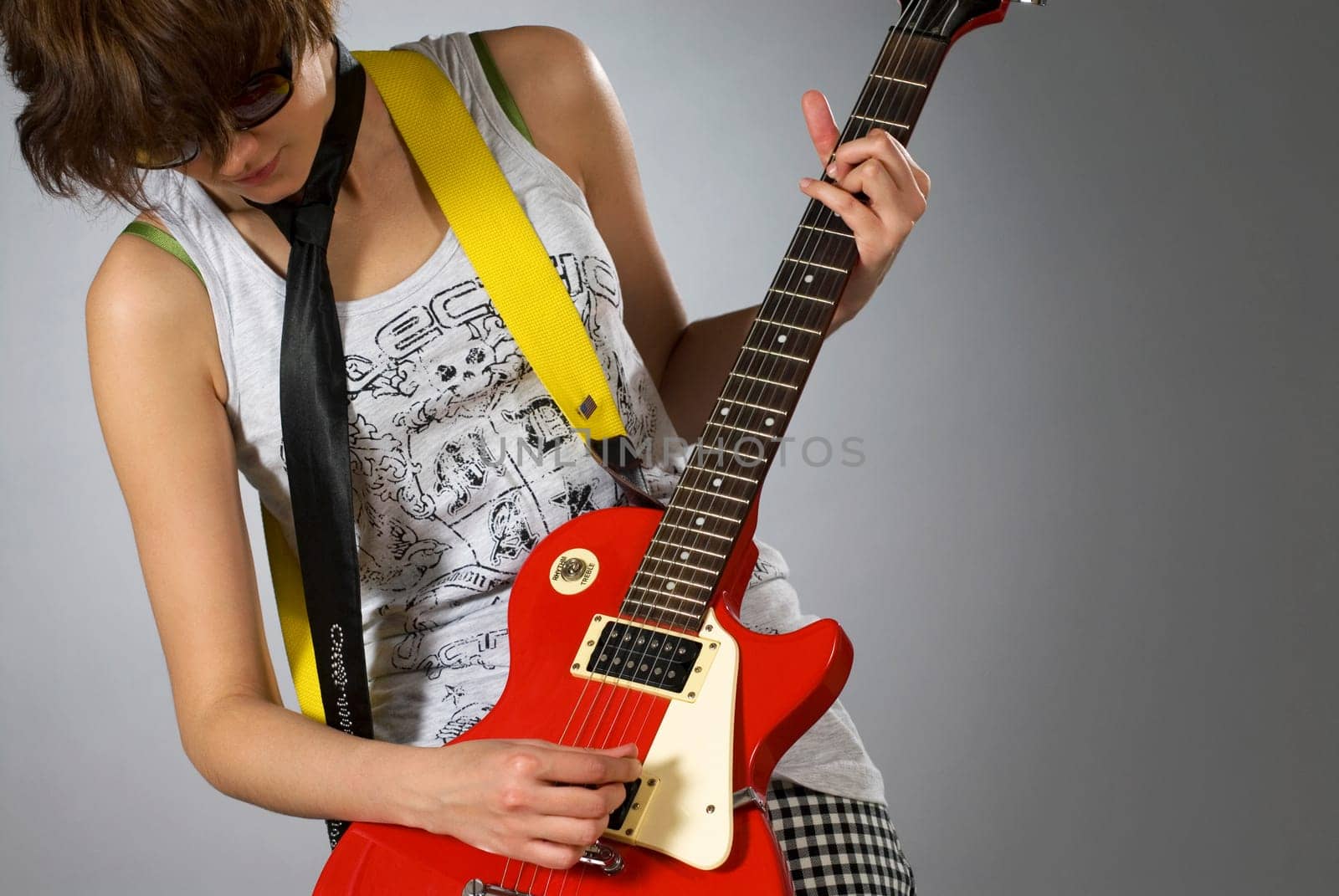 Close-up of a female guitarist playing a guitar