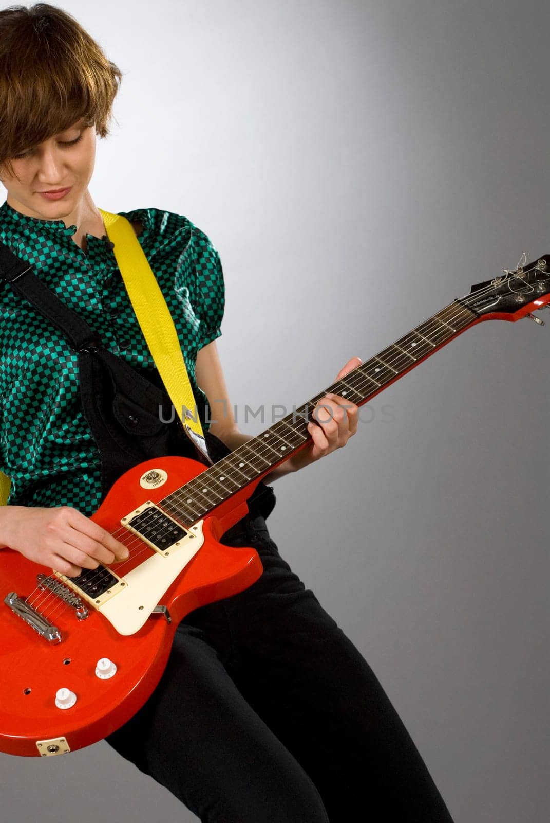 Close-up of a female guitarist playing a guitar