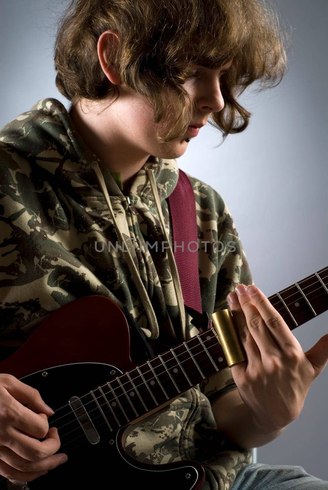 Close-up of a female guitarist playing a guitar