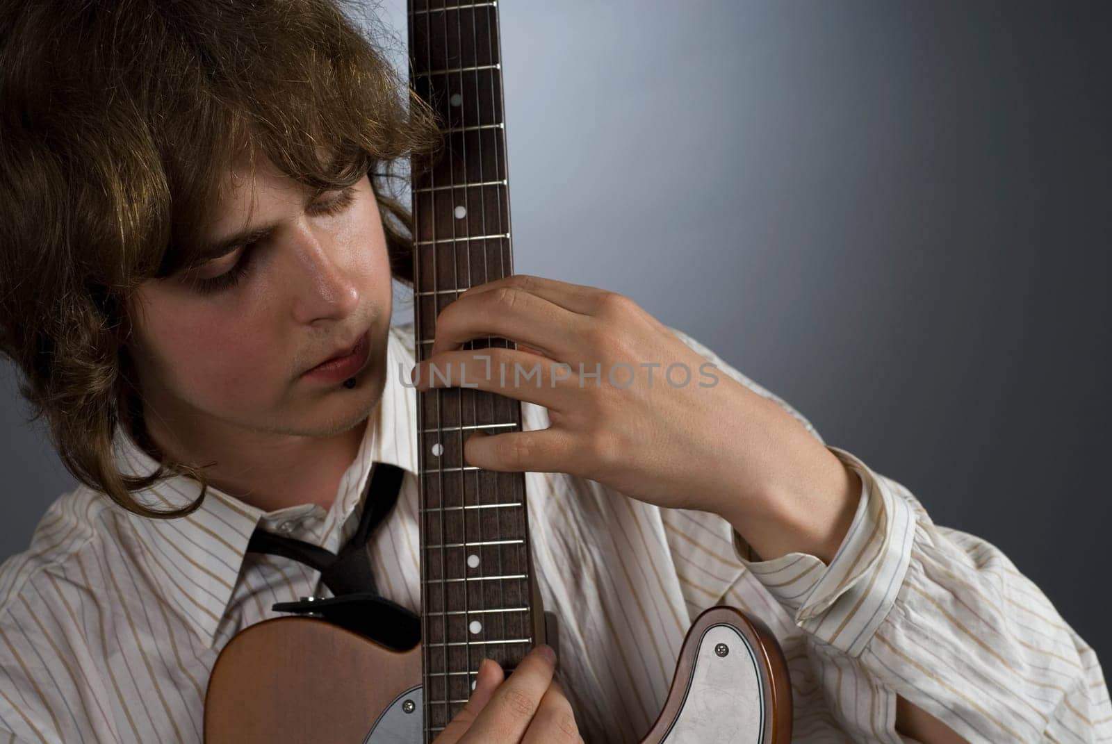 Close-up of a male guitarist playing a guitar