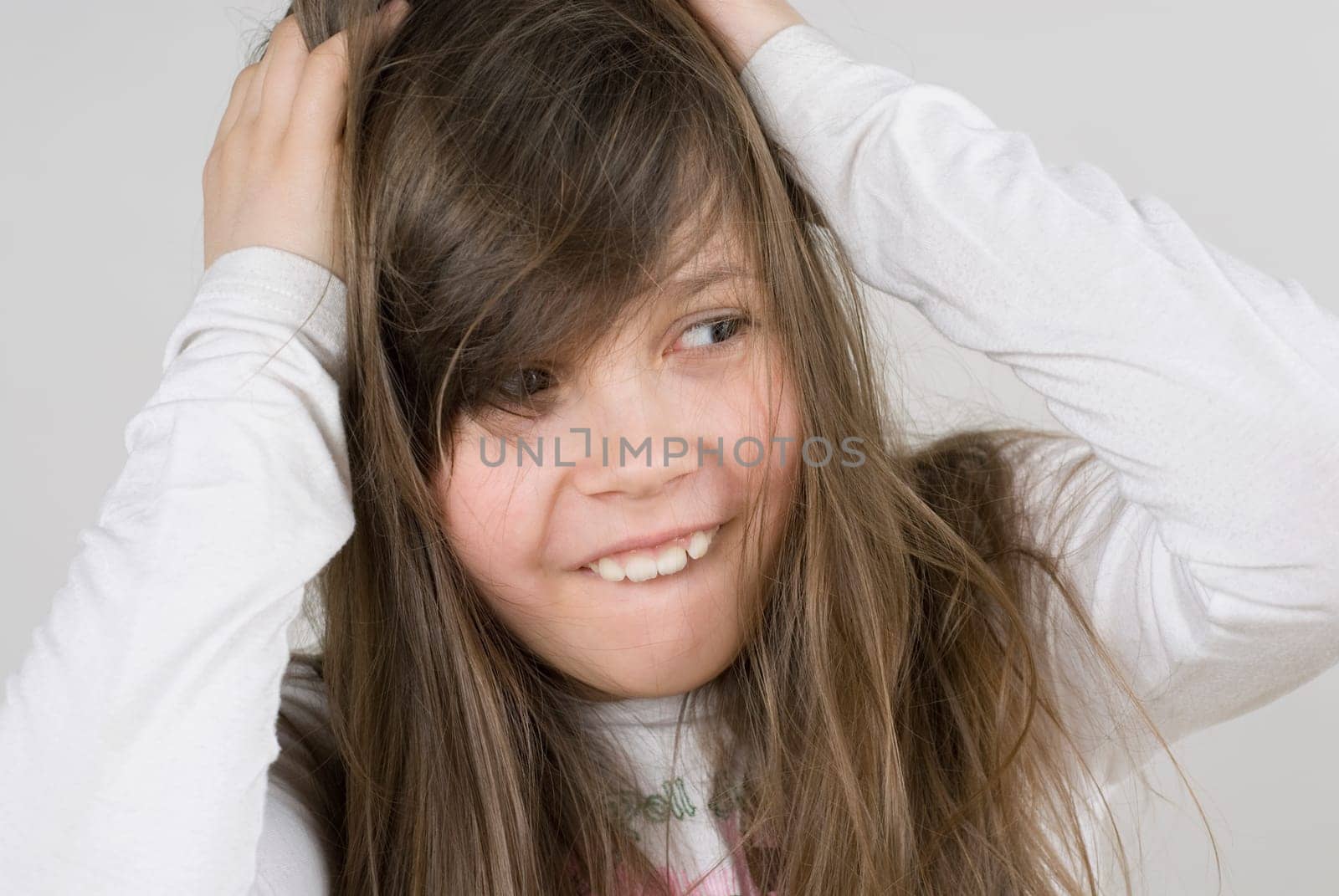 Close_up of a girl with her hands in her hair