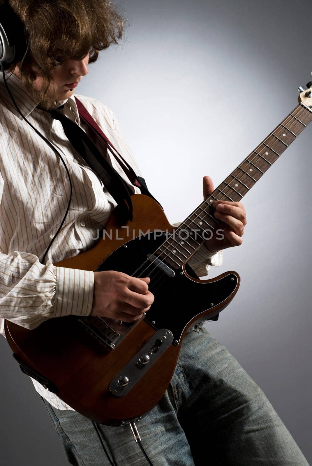 Close-up of a male guitarist playing a guitar