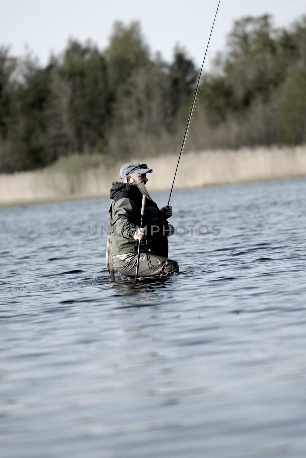 Side profile of a mature man fishing in the river