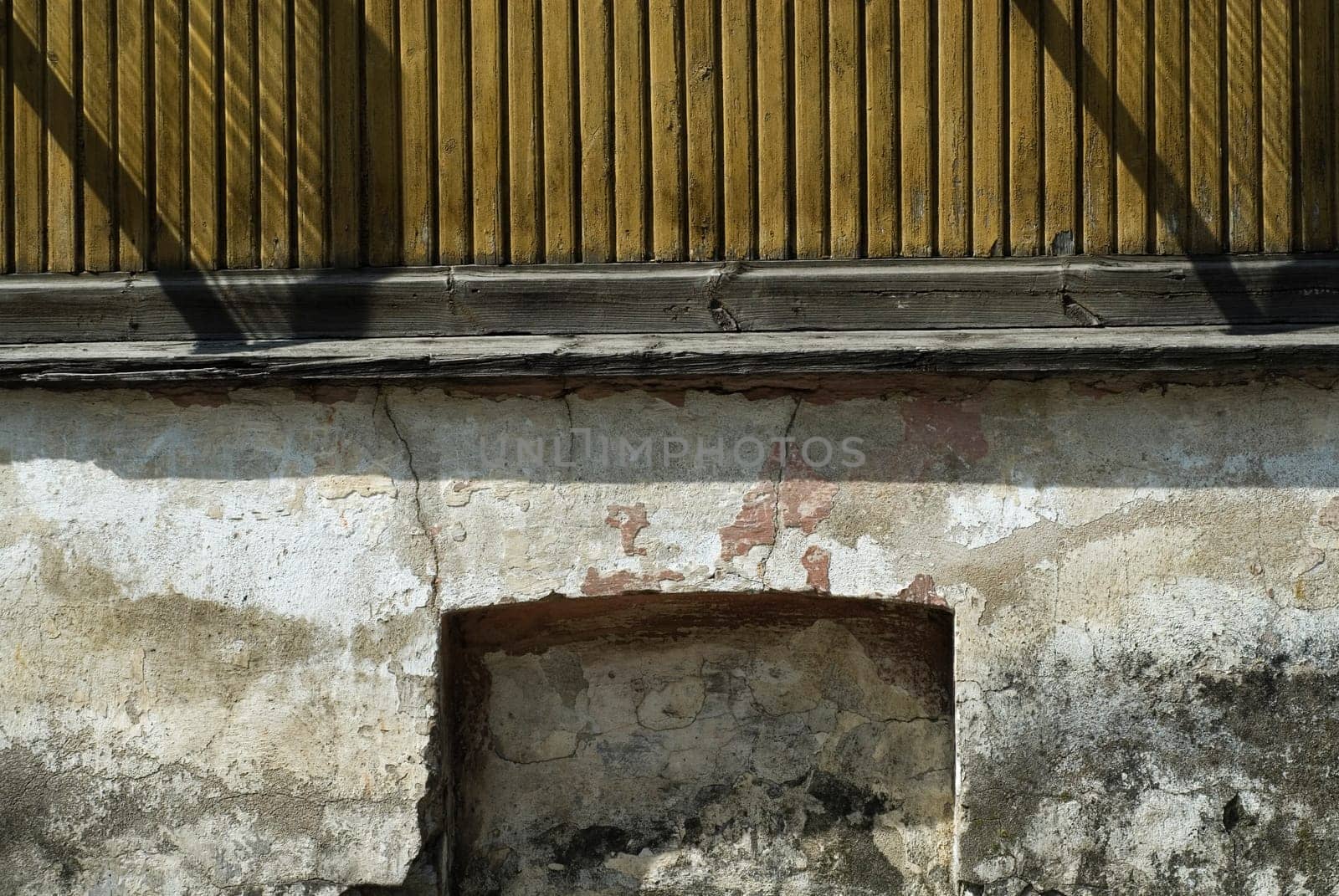 Close-up of a railing on a weathered wall