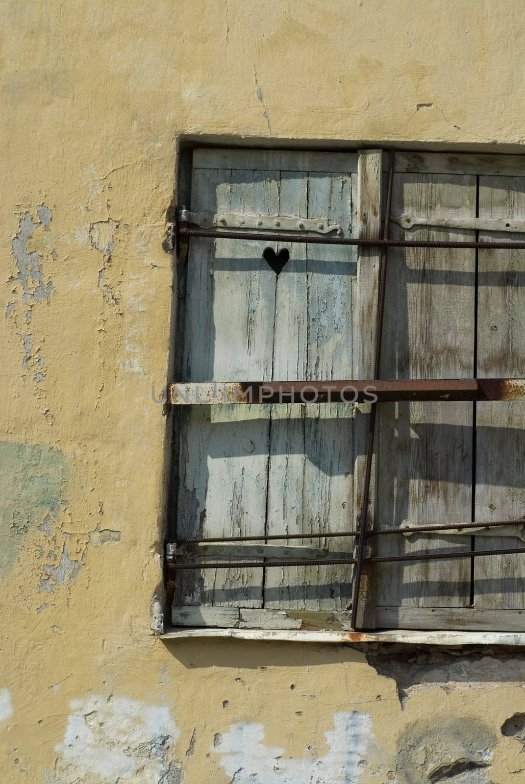 Close-up of an old window on a weathered wall