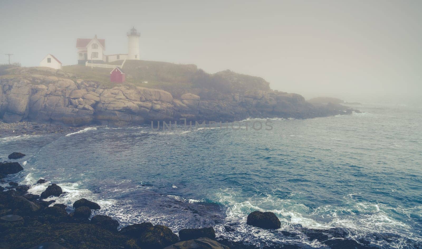 View of Nubble lighthouse in York, ME in dense fog
