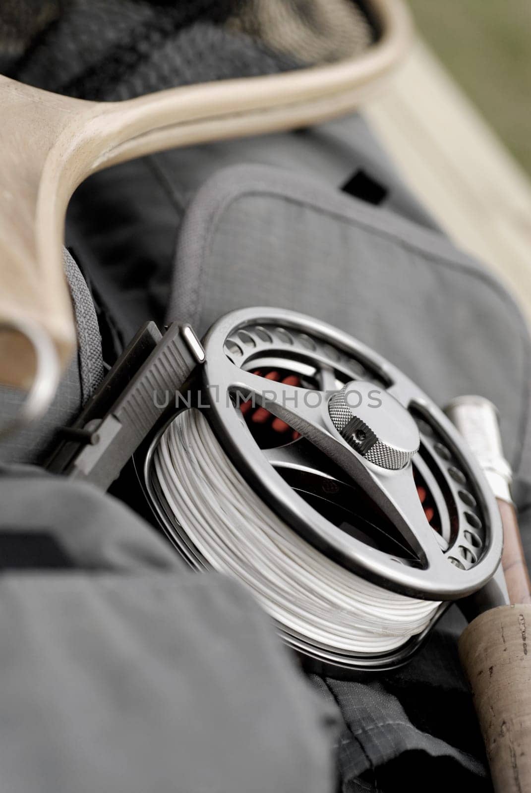 Close-up of a fishing reel and a fishing rod