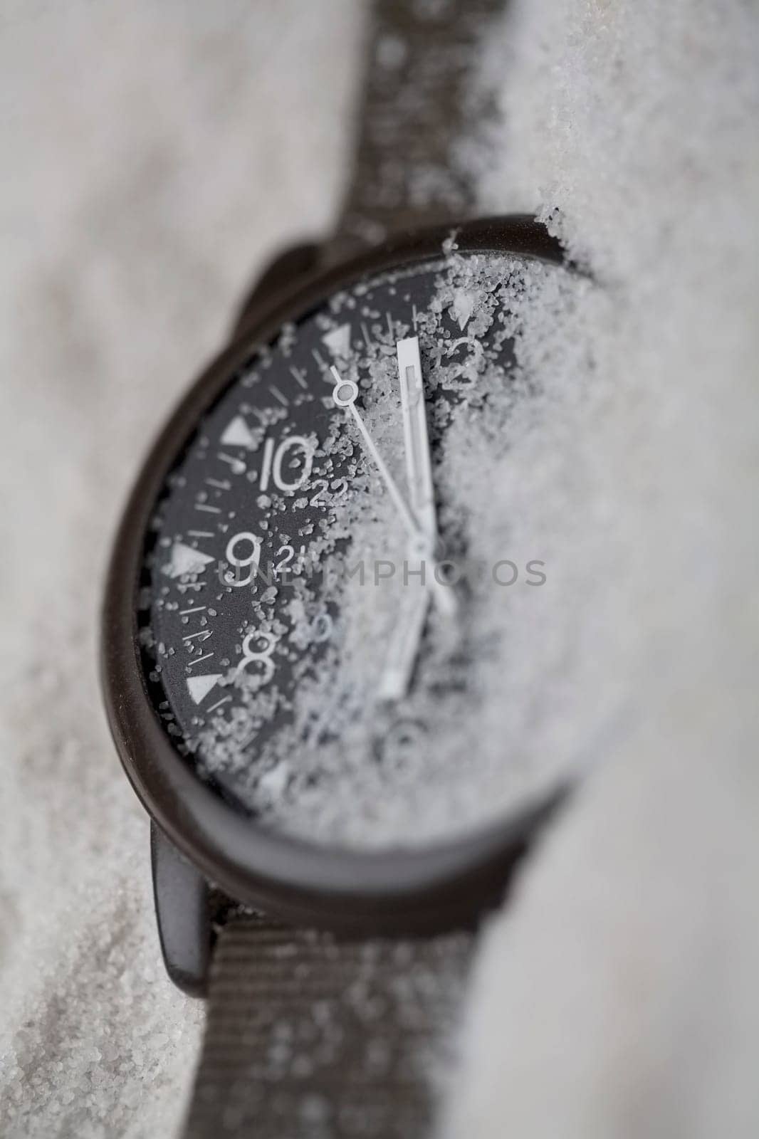 Close-up of a wristwatch in sand