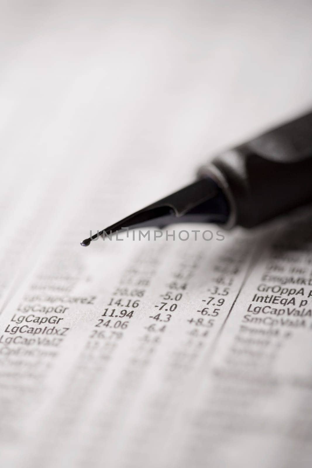 Close_up of a fountain pen on a financial newspaper