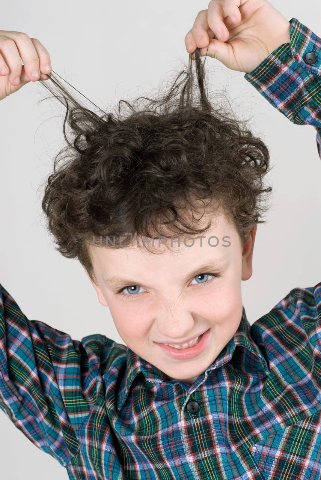 Close_up of a boy pulling his hair
