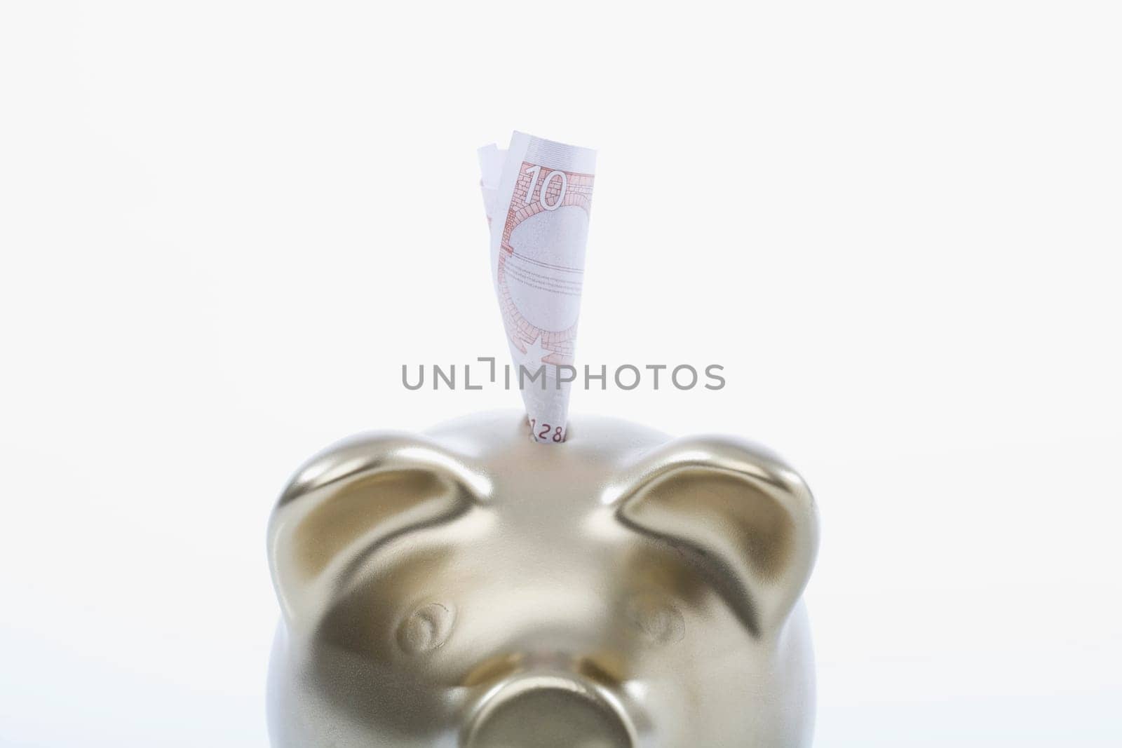 Paper currency sticking out of a piggy bank