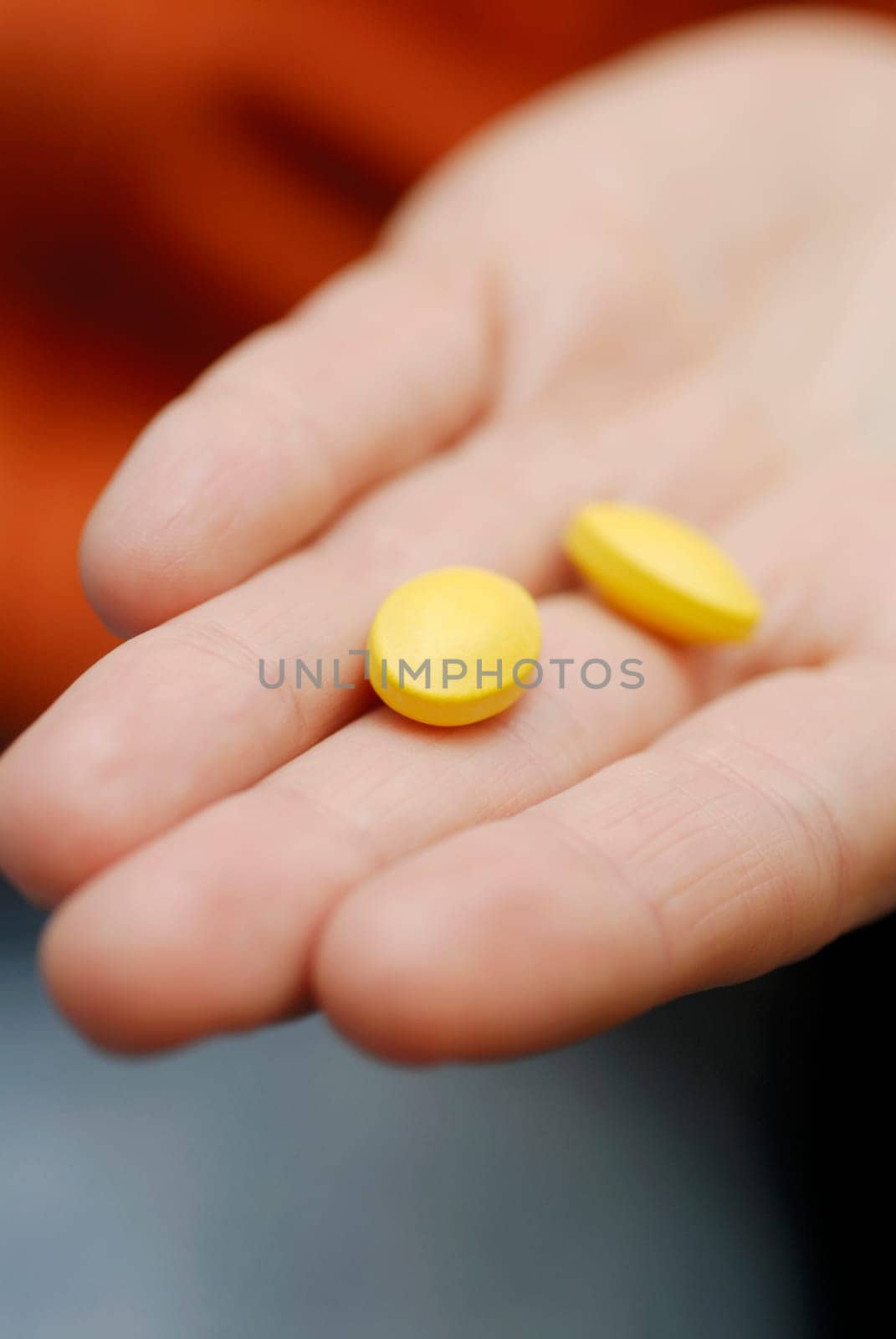 Close-up of two pills on a personŽs hand