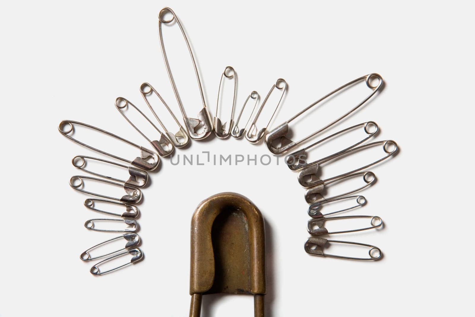 Close-up of safety pins arranged in a circle