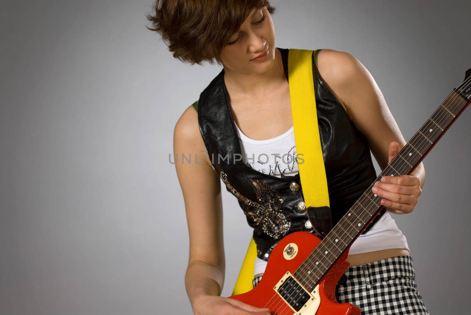 Close-up of a female guitarist playing a guitar