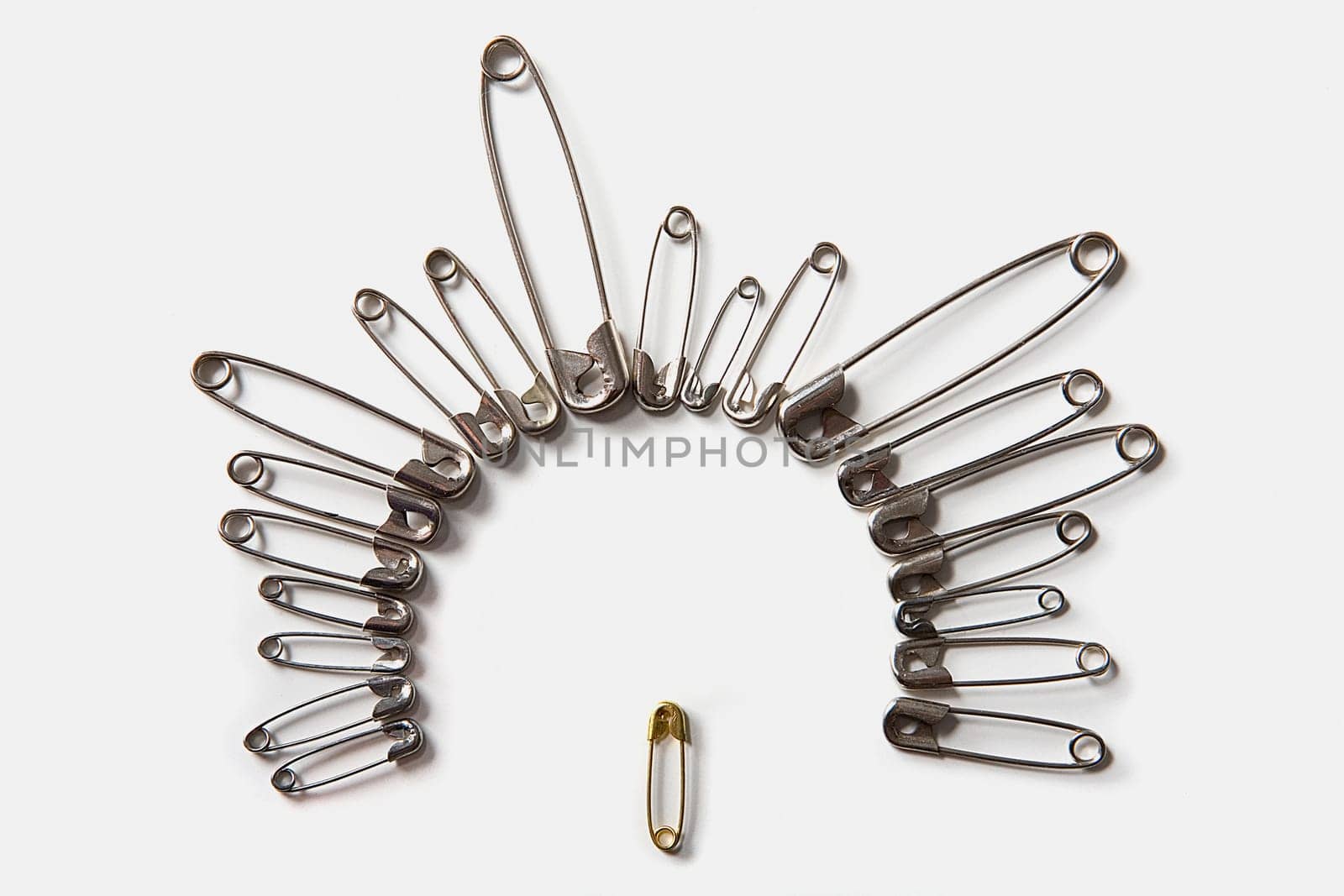 Close-up of safety pins arranged in a circle