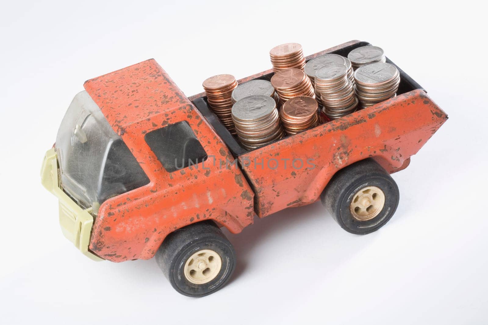 High angle view of a toy truck loading stacks of coins
