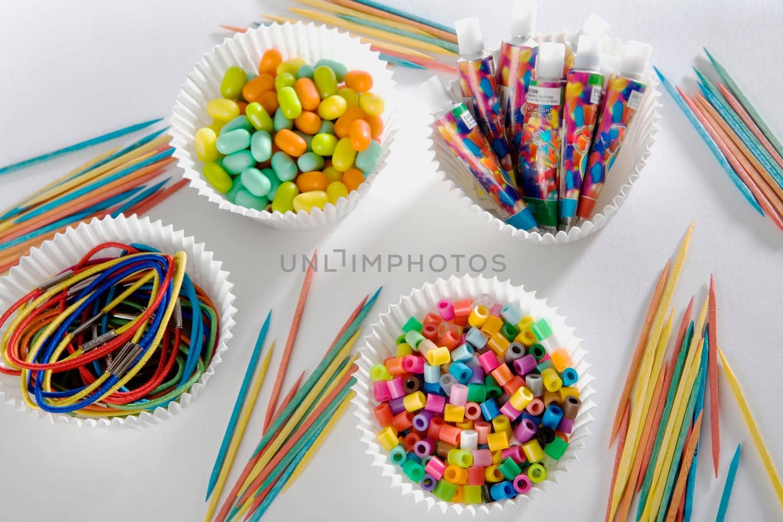 Close-up of toothpicks with multi-colored strings and candy