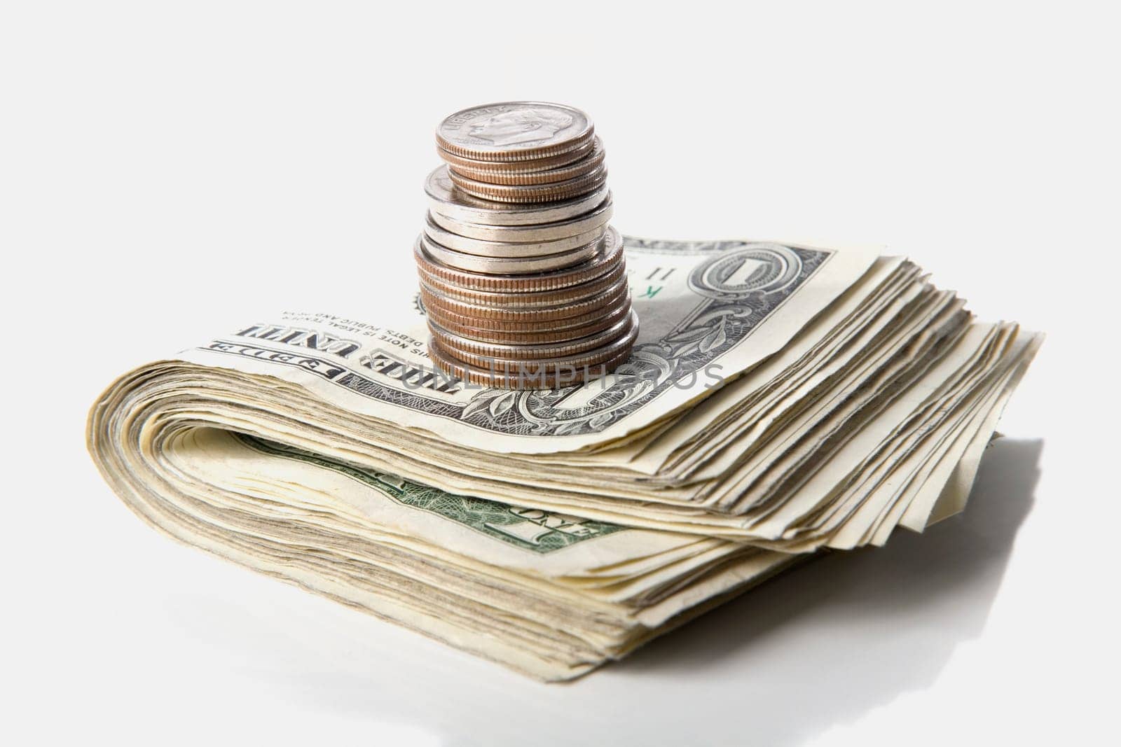 Close-up of a stack of paper currency and coins