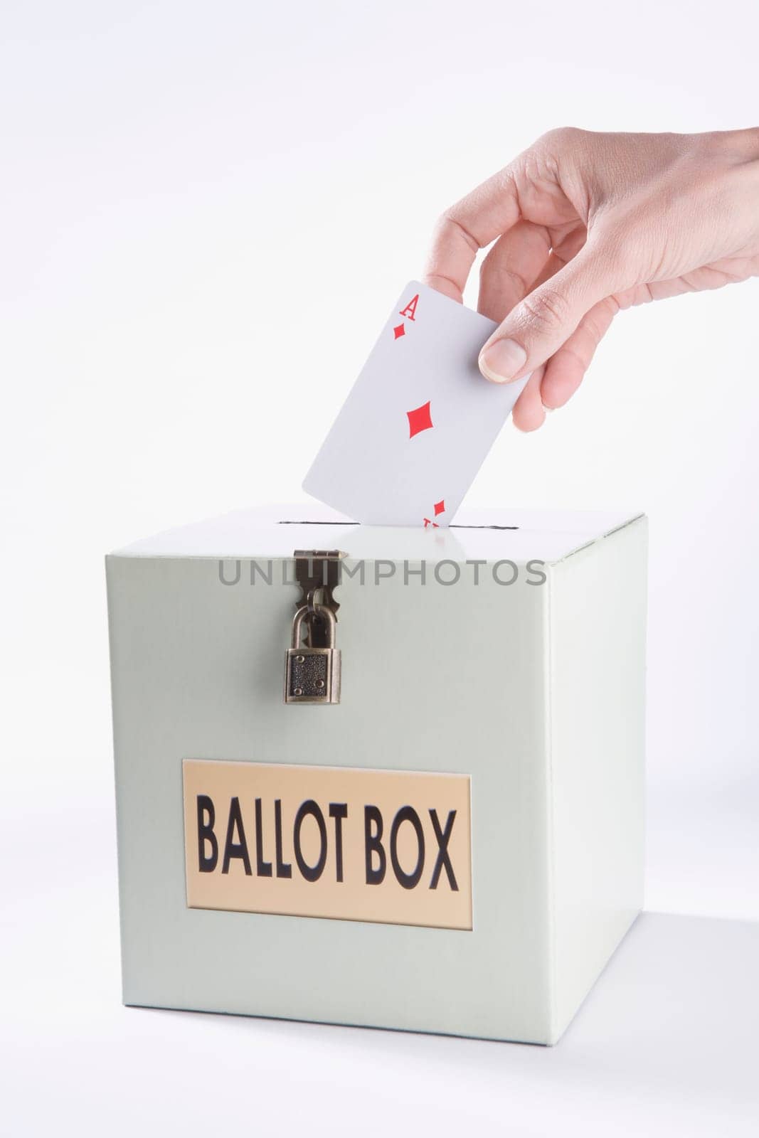 PersonŽs hand inserting a playing card into a ballot box