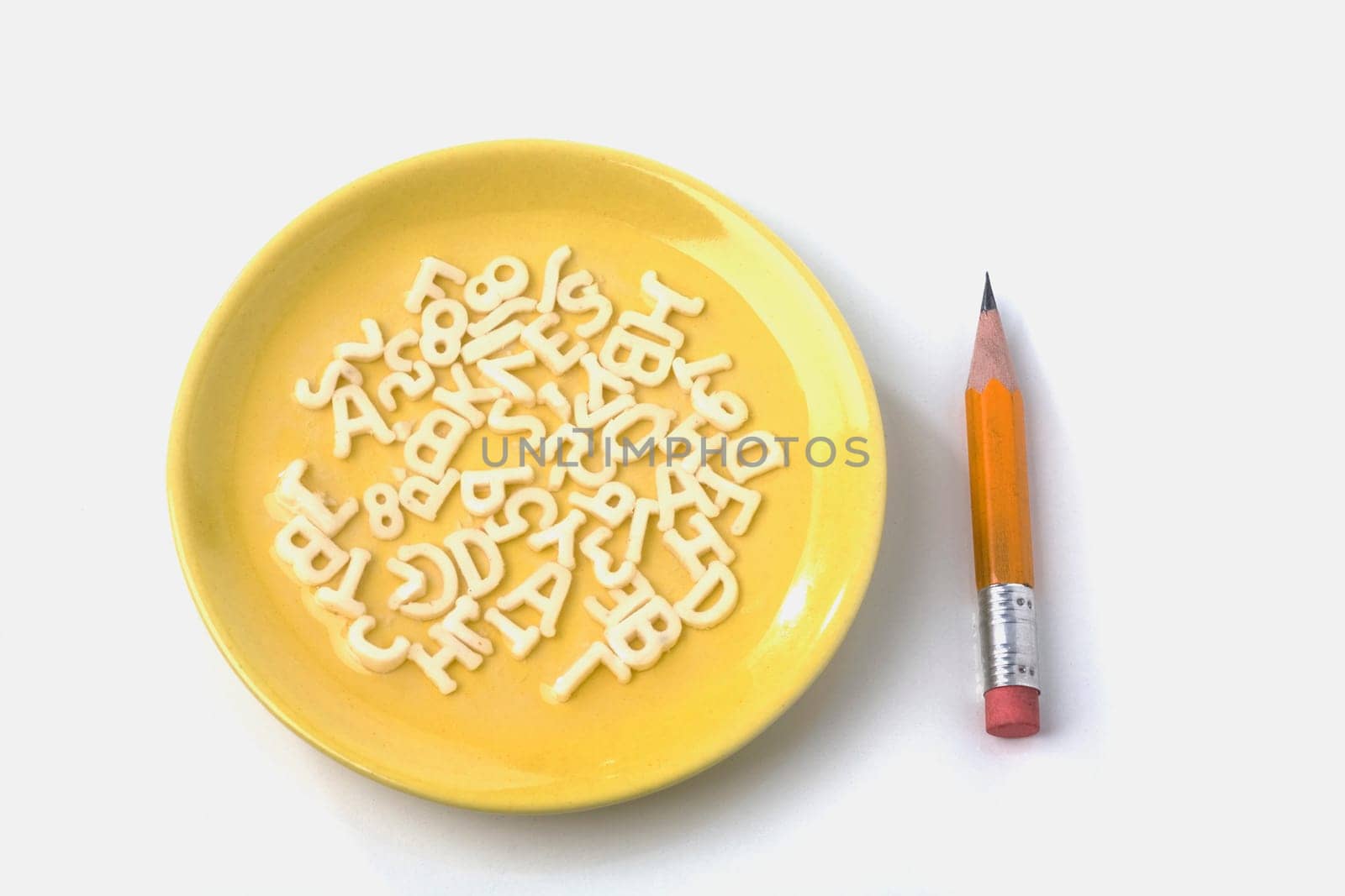 Close-up of a plate and a pencil