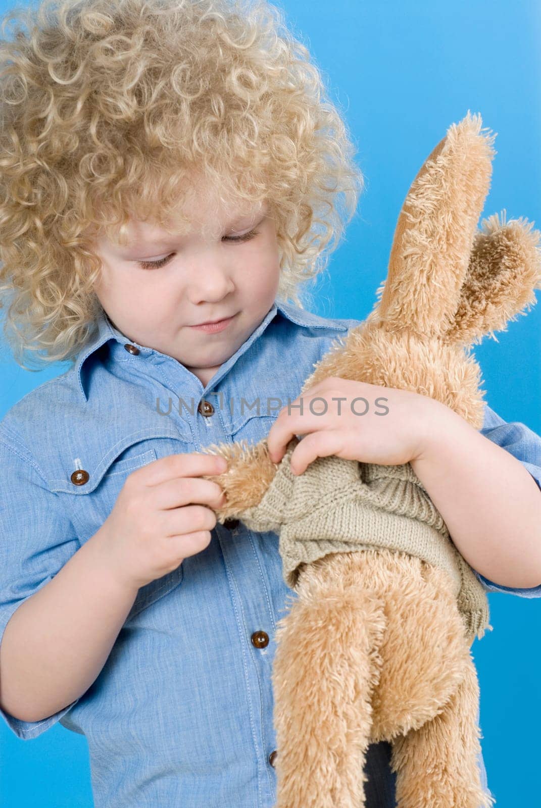 Close_up of a boy holding a teddy bear